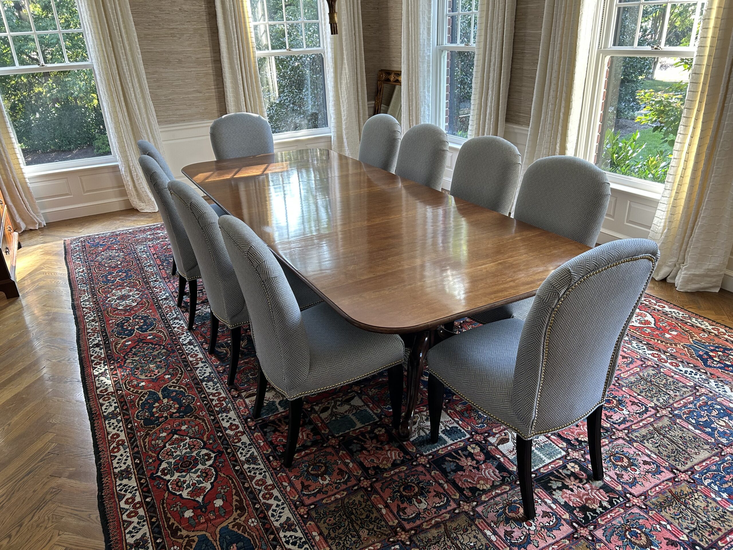 Dining table with 10 gray chairs